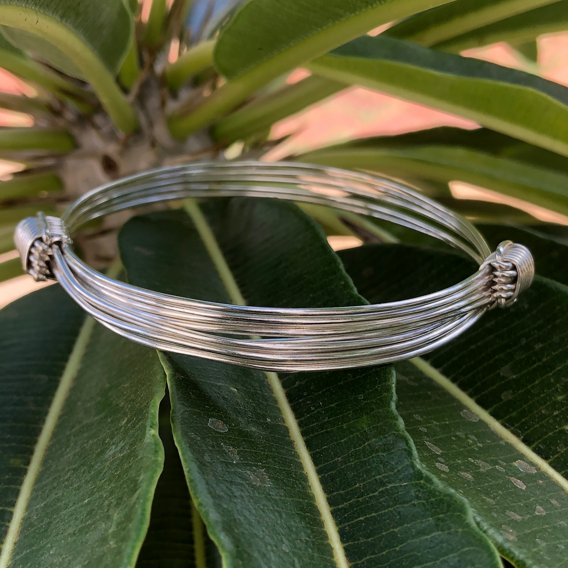 One size fits all 5 strand 2 knot bangle made in africa in sterling silver