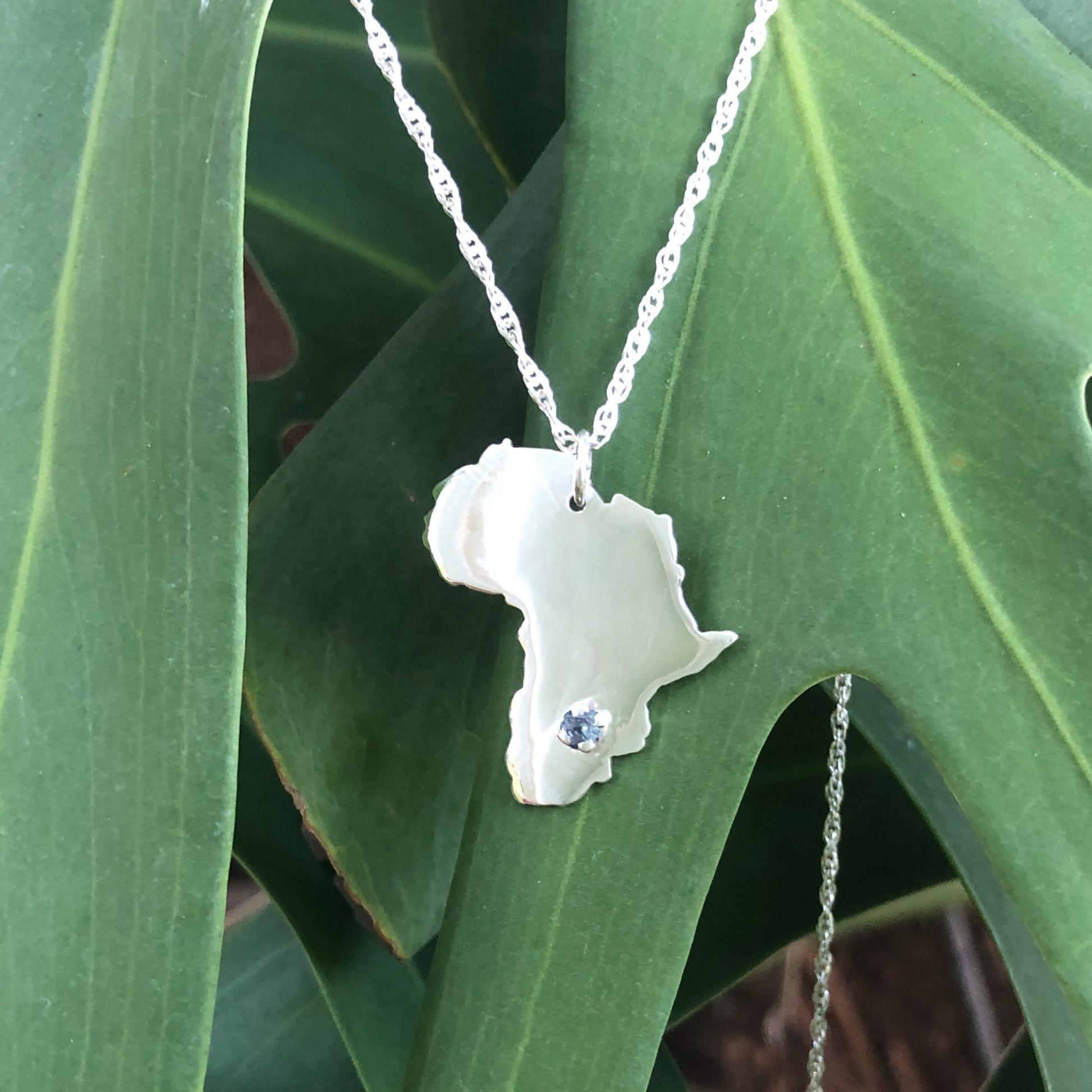 Silver African Map Necklace With a gemstone
