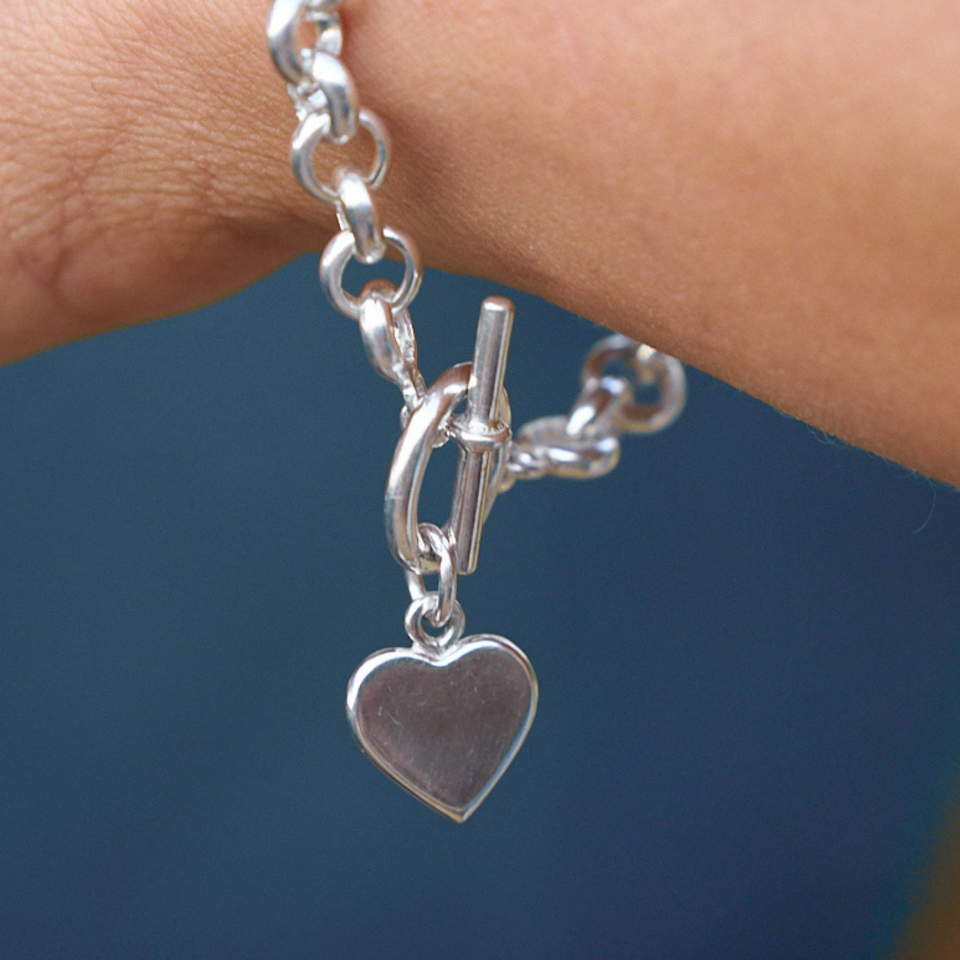 Handmade rolo chain bracelet with a heart charm